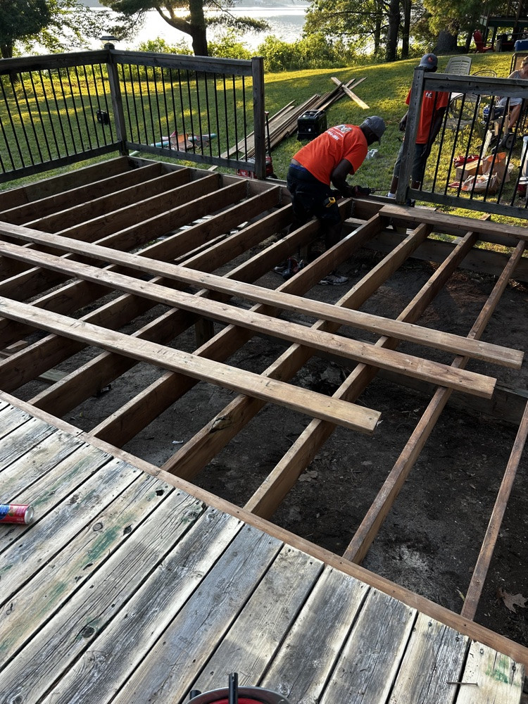 Crew re-boarding a deck on exposed framing