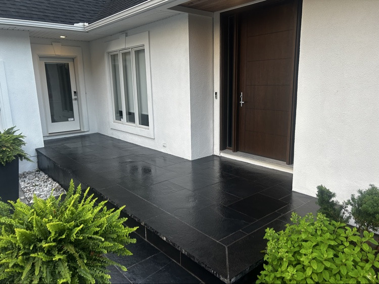 Sealed black natural-stone porch and entry