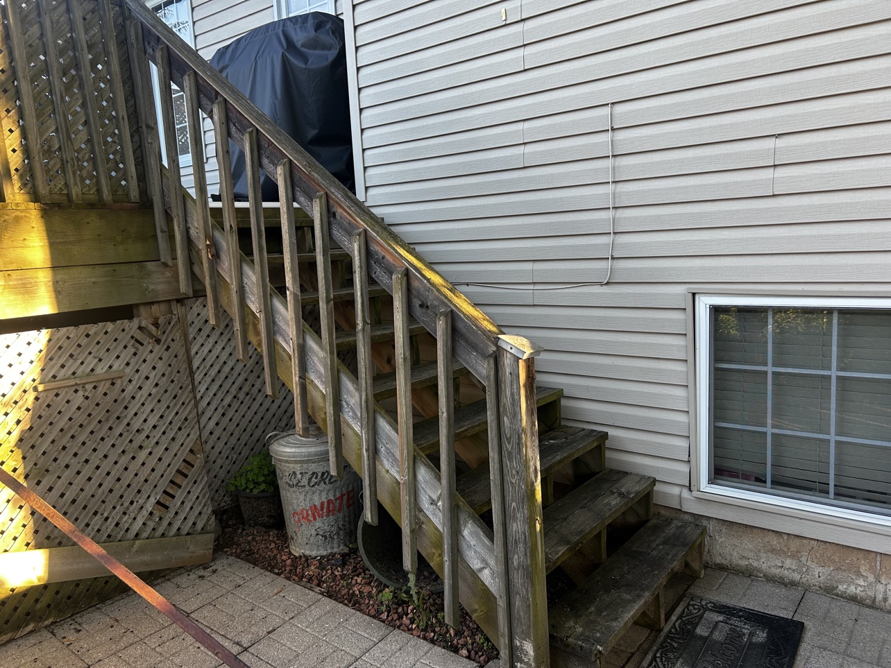 Weathered grey deck stairs before replacement